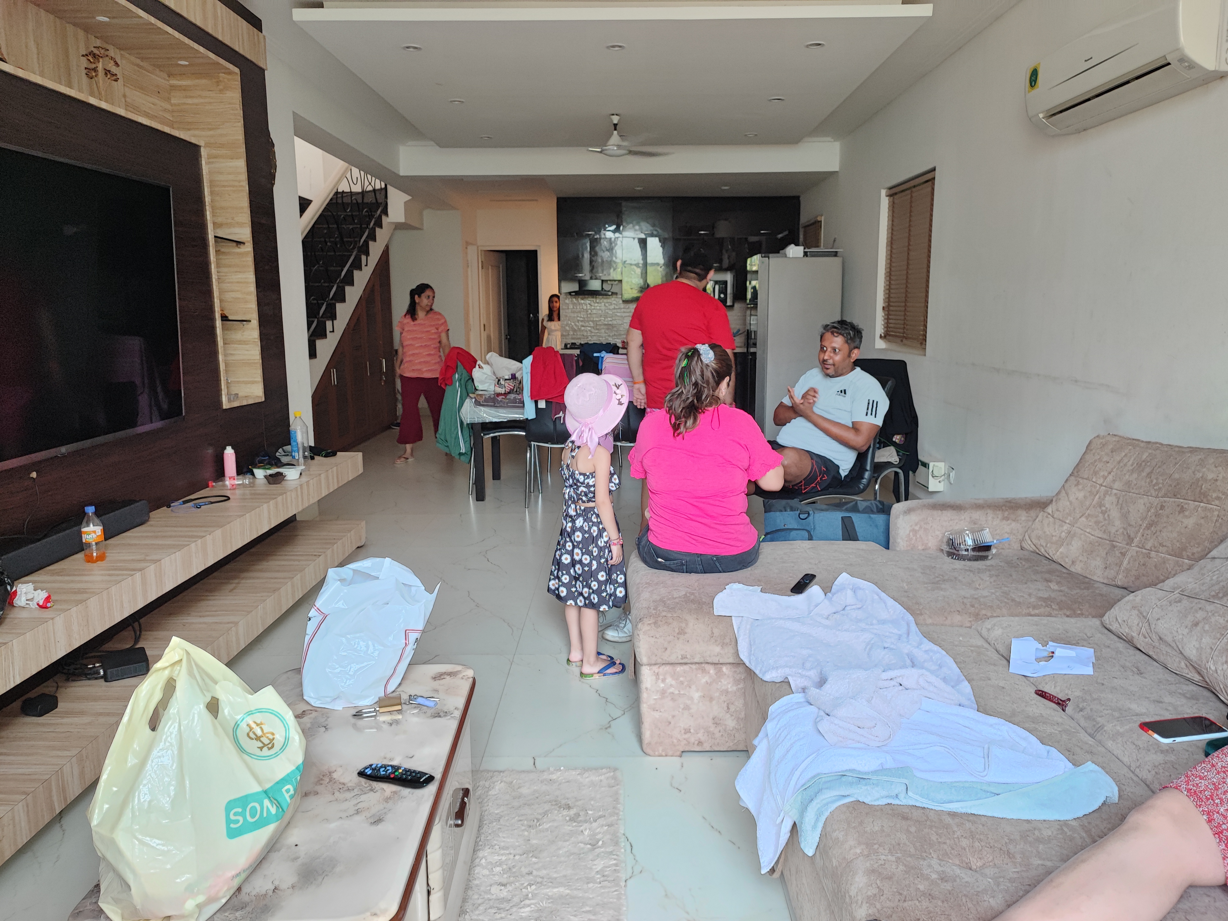 Family gathered casually in our Goa villa living room.