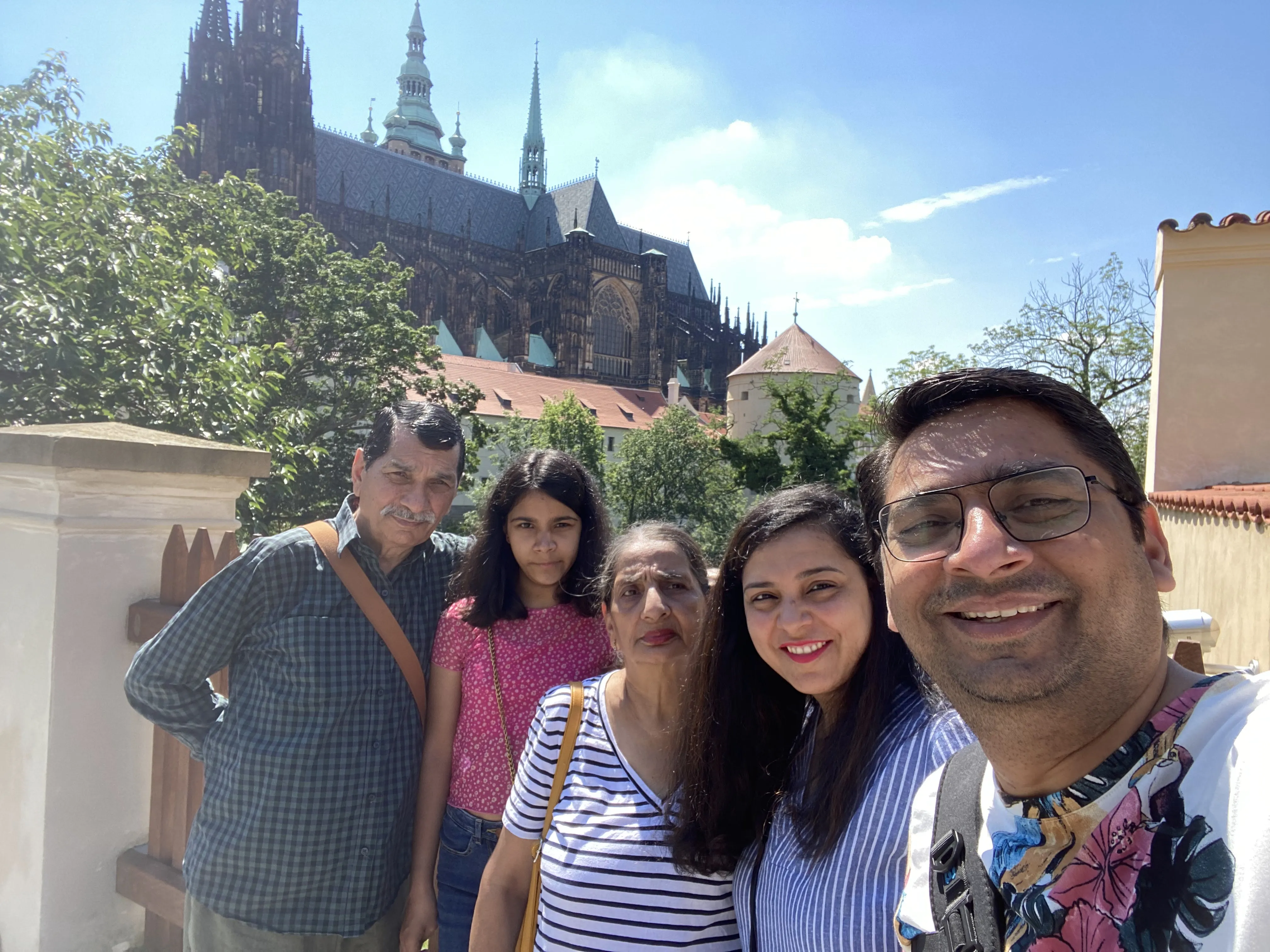 My father and I smiling together with Prague Castle's spires visible in the background.